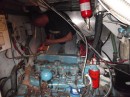 Tom working in the engine on the high seas.