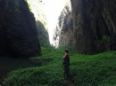 At the base of Vaipo waterfall, surrounded by canyon walls, lush folliage, and pool of water.