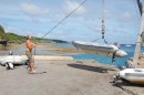 RarotongaNiue 068_1_1: Uwe hoists the dinghy on the crane at Niue, the only way of landing 