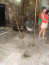 These sticks are used by government officials to measure the amount of rum.  The rum is locked in vats below the floor and cannot be sold until measured. Dora in background.