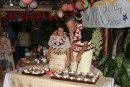 7) Andrew (12) and Earl (60) cutting their cakes - look at all of the beautiful flowers in the background used for decorating! :)