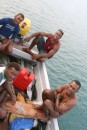 Some of the fisherman from the Somosomo village.  They go to the outer reef areas and free dive to collect and spear their daily wares. If you can blow this up, you might see the turtle they caught wrapped up under the seat in the middle of the boat :(