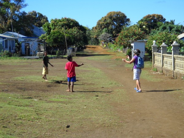 Debbie playing catch with the boys on the main village road