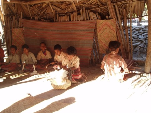 Children helping with the weaving at Bote Village