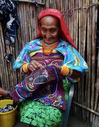 Guna woman making a mola: This lovely lady was over 80 years old and still sewing. Unbelievably she doesn’t need glasses. 

