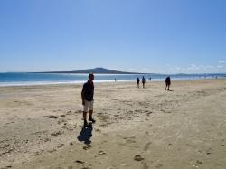 Walking on Takapuna Beach : Rangitoto in the background is New Zealands youngest volcano rising out of the sea just 600 years ago. Rangitoto is a nature reserve but you can catch the ferry over to the island and walk to the top.